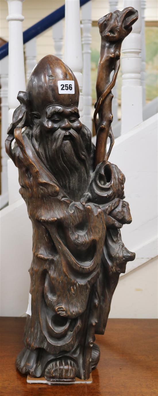 A Chinese rootwood carving of a sage with a staff height 69cm